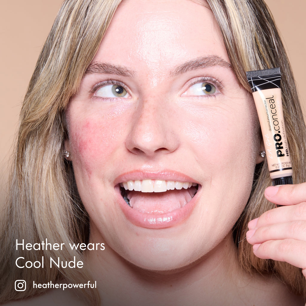Heather smiling and holding HD PRO.Conceal Cool Nude beside her cheek.