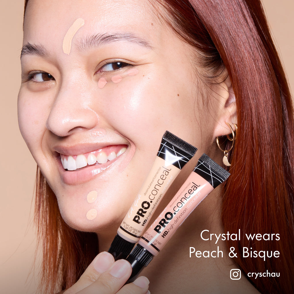 Crystal smiling and holding HD PRO.Conceal Peach and Bisque beside her cheek.
