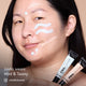 Linda with HD PRO.Conceal Mint and Tawny striped across her cheek and forehead, holding both tubes.