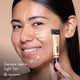 Genesis with HD PRO.Conceal Light Tan applied beneath her eyes and along her forehead, nose and chin, holding a tube.