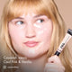 Cassarah with HD PRO.Conceal Cool Pink and Vanilla applied beneath her eyes and along her jaw, holding a tube.