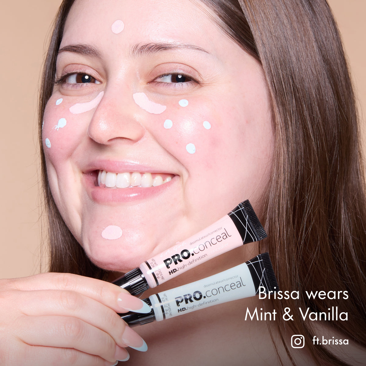 Brissa with HD PRO.Conceal Mint and Vanilla dotted beneath her eyes and on her forehead and chin, holding both tubes.