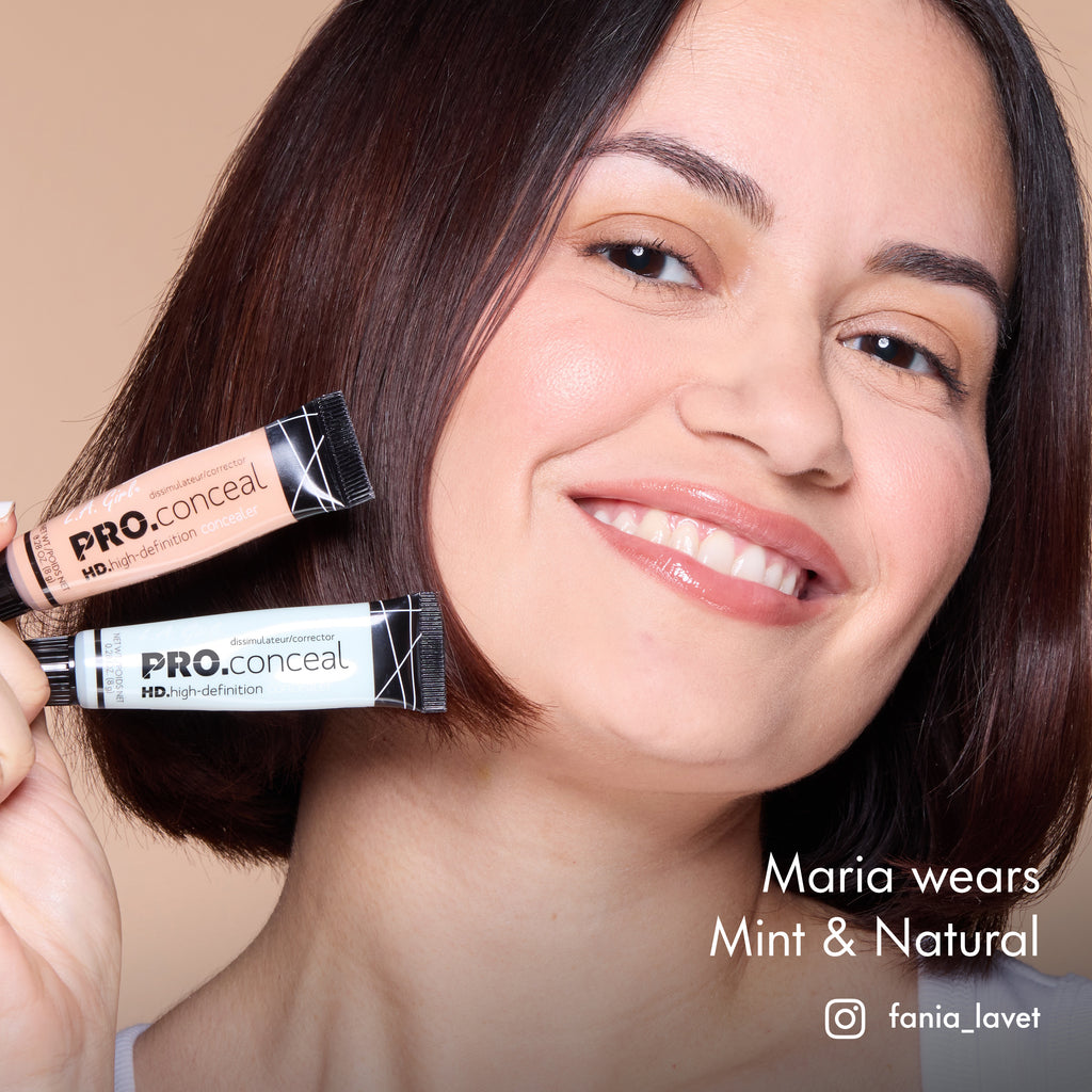 Maria smiling and holding HD PRO.Conceal Mint and Natural beside her cheek.