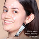 Maria with HD PRO.Conceal Mint and Natural dotted and striped across her face, holding the Mint tube.
