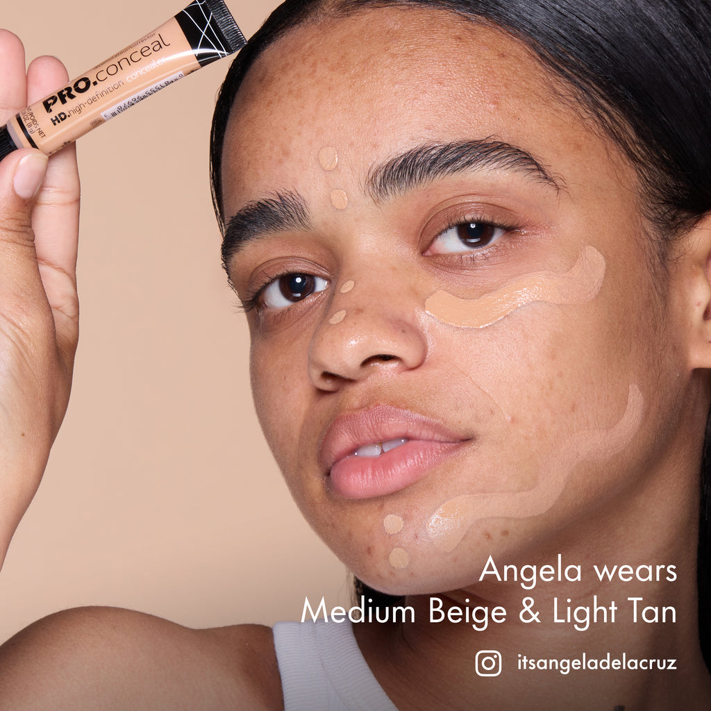 Angela with HD PRO.Conceal Medium Beige and Light Tan applied beneath her eyes and along her forehead and jaw, holding a tube.
