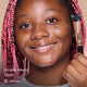 Janelle smiling and holding HD PRO.Conceal Toast beside her cheek.