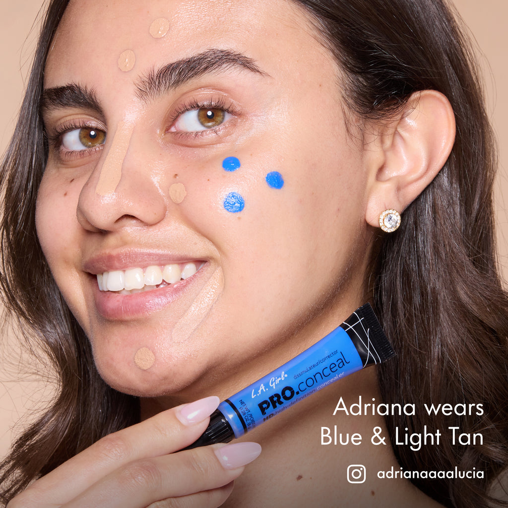 Adriana smiling with HD PRO.Conceal Blue and Light Tan dotted across her face, holding the Blue tube.