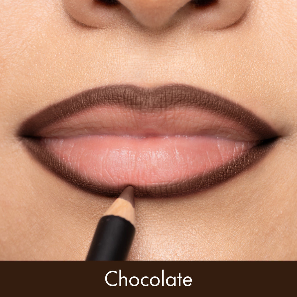 Close-up of a person applying chocolate-colored lipstick with a pencil.