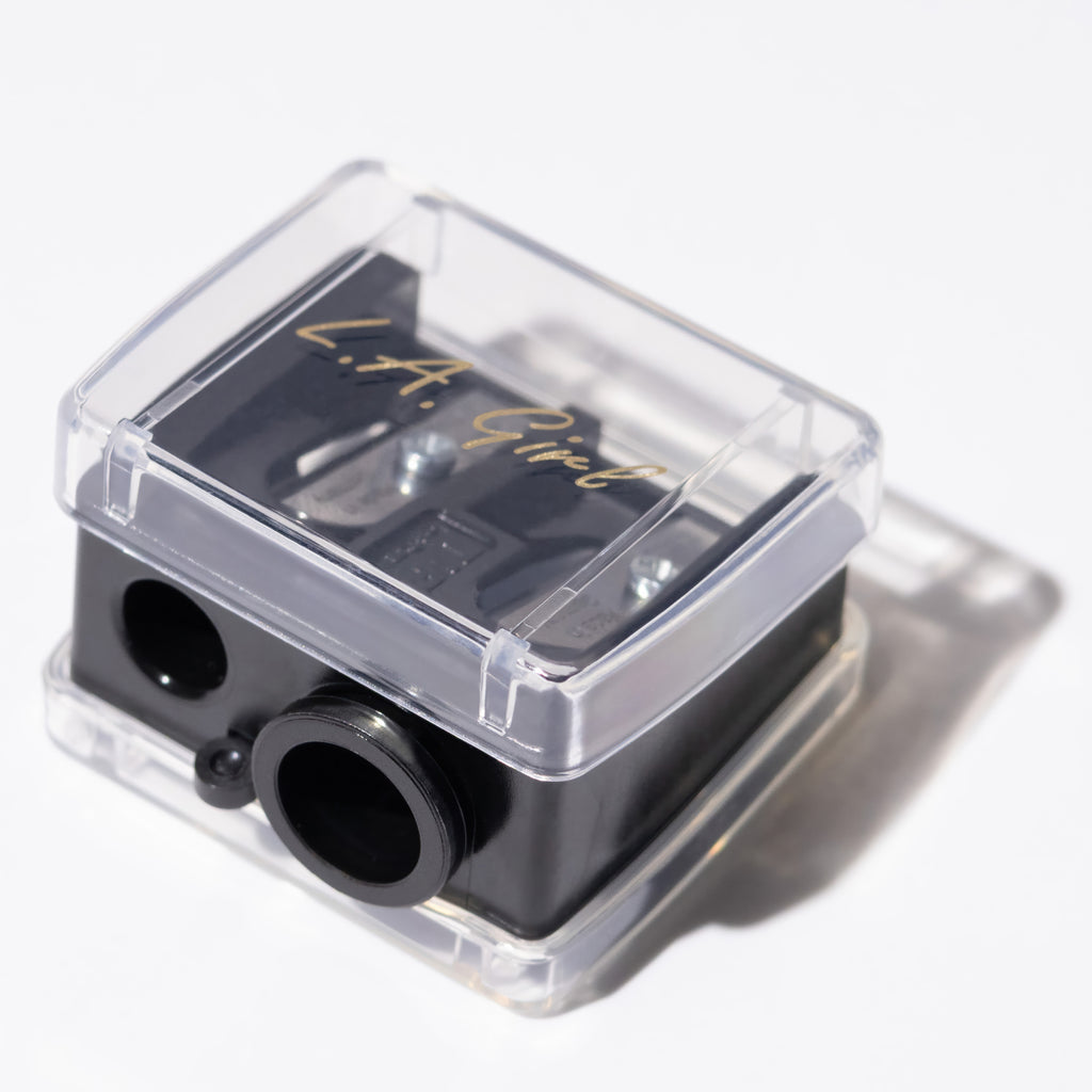 Black and clear pencil sharpener with 'L.A. Girl' branding on a white background